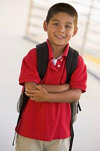Student standing outdoors smiling (high key)