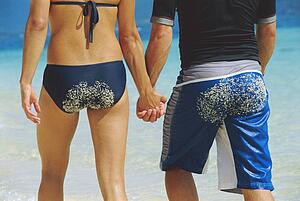 Couple holding hands at the beach (selective focus)