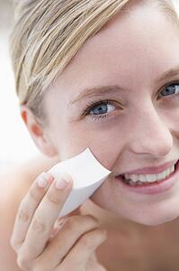Woman removing makeup smiling