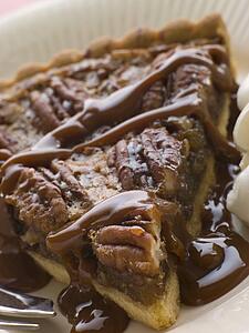 Slice Of Pecan Pie With Caramel Sauce And A Fork