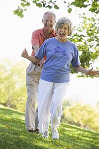 Senior couple walking in park together