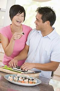 Couple Preparing Sushi Together 