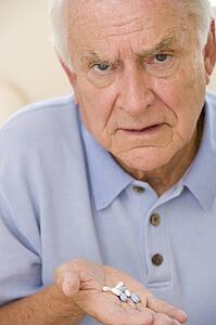 Senior Man Holding Prescription Drugs