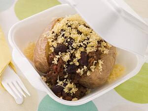 Baked Potato With Chilli Con Carne And Cheese In A Take Away Box
