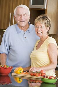 Husband And Wife Preparing Vegetables