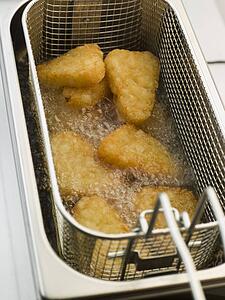 Hash Browns being Deep Fried in Corn Oil
