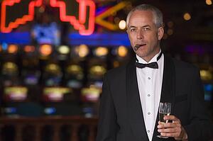 Man in casino with cigar and champagne (selective focus)