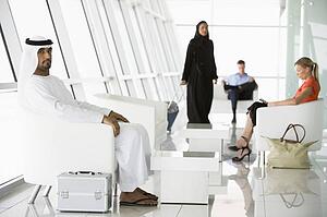 Airline passengers waiting in departure gate