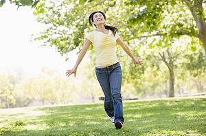 Woman running outdoors smiling