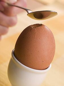 Boiled Egg being cracked open with a spoon