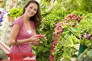 Woman shopping for beets at a grocery store