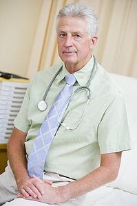 A Doctor Sitting On A Hospital Bed