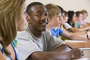 Students in class paying attention and taking notes (selective focus)