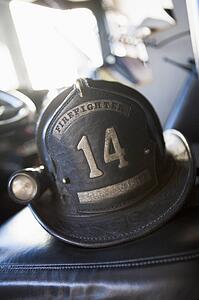 Firefighting helmet in fire engine on seat (selective focus)