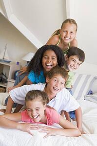 Five Young Friends Lying On Top Of Each Other