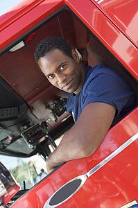 Fireman in driver's seat of fire engine