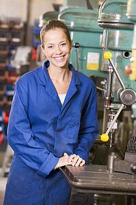 Machinist working on machine