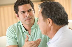 Two men in living room arguing