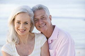 Couple at the beach smiling