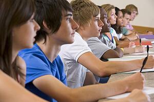 Students in class paying attention and taking notes (selective focus)
