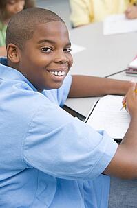 Student in class writing (selective focus)