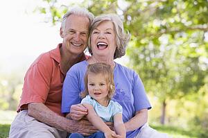 Grandparents with granddaughter in park