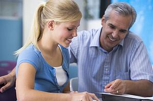 Teacher giving personal instruction to female student