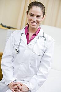 A Doctor Sitting On A Hospital Bed