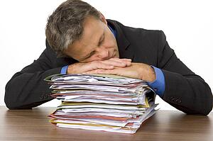 Businessman Overwhelmed By Paperwork