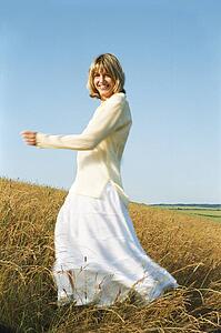 Woman spinning outdoors smiling