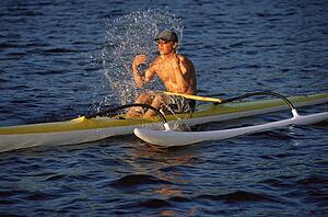 Kayaker outdoors splashing water on face