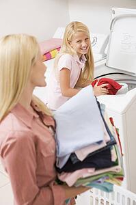 Mother And Daughter Doing Laundry 