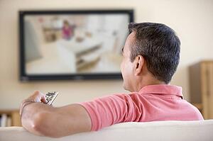 Man in living room watching television