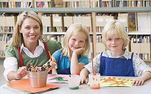 Two students in art class with teacher