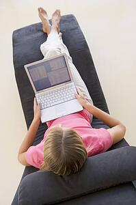 Woman sitting in chair using laptop