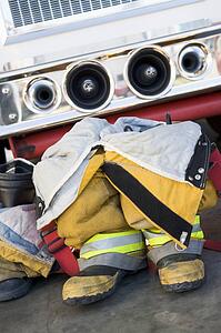 Firefighting uniforms in front of a fire engine