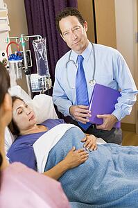 Doctor Standing In Patients Room