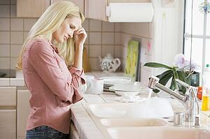 Woman Frustrated At Kitchen Counter 
