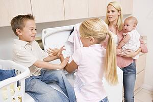Siblings Fighting While Doing Laundry 
