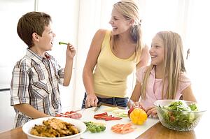 Mother And Children Prepare A meal, mealtime Together 