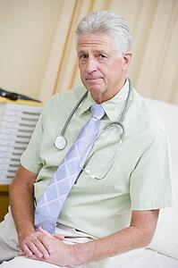 A Doctor Sitting On A Hospital Bed