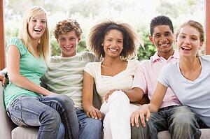 Group Of Teenagers Sitting On A Couch