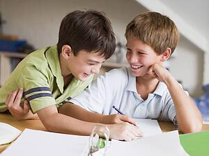 Two Young Boys Doing Their Homework Together