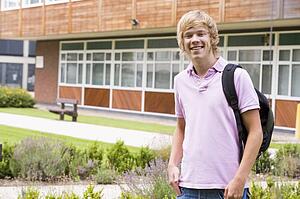 Student standing outdoors smiling