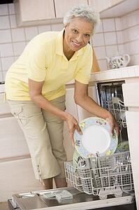 Woman Loading Dishwasher 
