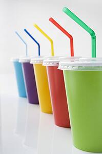 Row Of Coloured Soft Drink Beakers With Straws