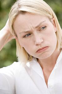 Head shot of woman scowling