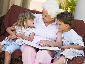Grandmother reading to grandchildren.