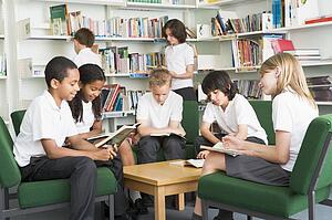 Seven students in library reading books