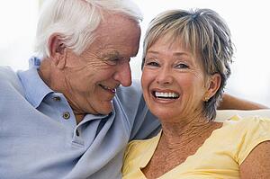 Couple relaxing in living room and smiling